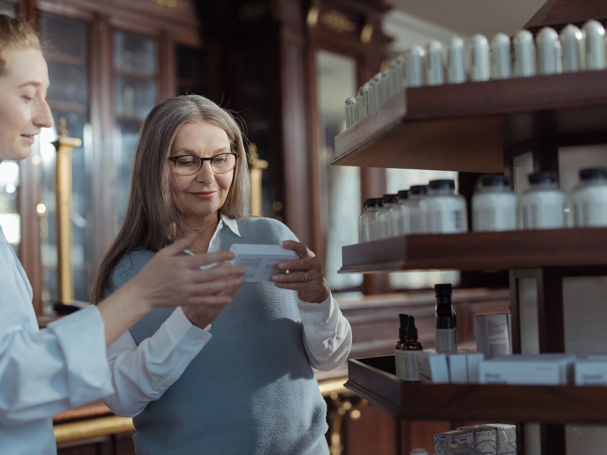 Pharmacienne conseillant une cliente sur le choix d'un redresse-dos